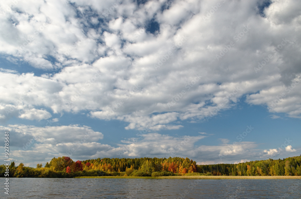 Landscape colorful autumn forest lake river sky clouds