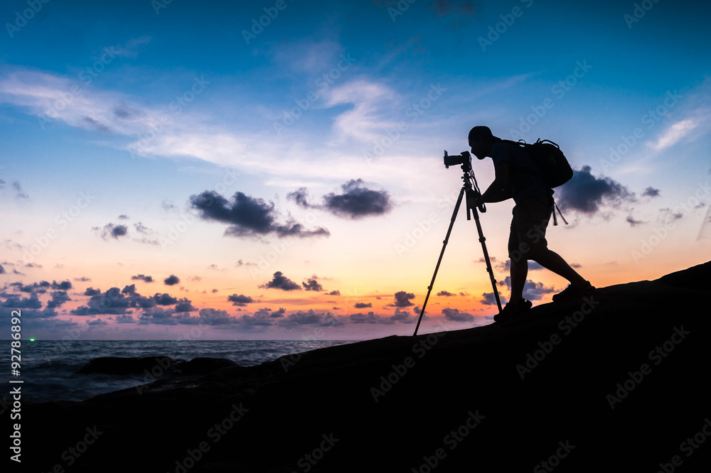 Silhouette photographer on the beach