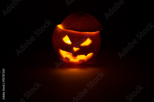 halloween orange fruit jack  lantern on dark