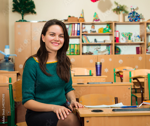 teacher in classroom near desks