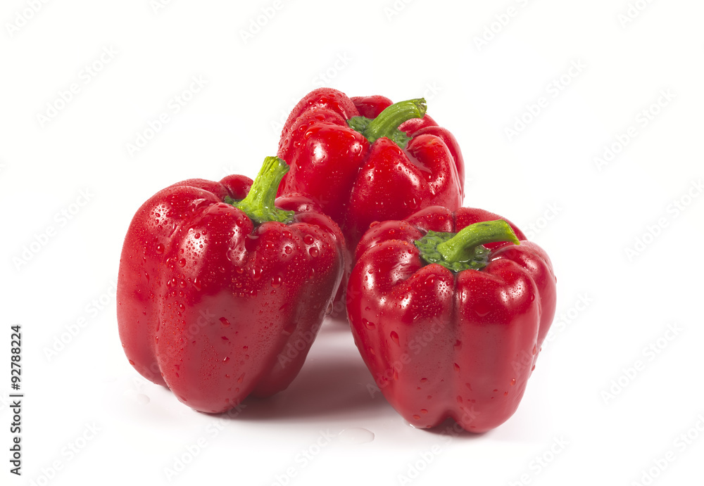 Three red sweet peppers isolated on white