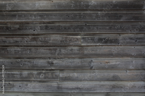The background of weathered grey painted wood