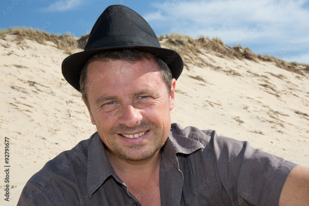 Handsome man with a hat looking at the camera Handsome man with a hat looking at the camera