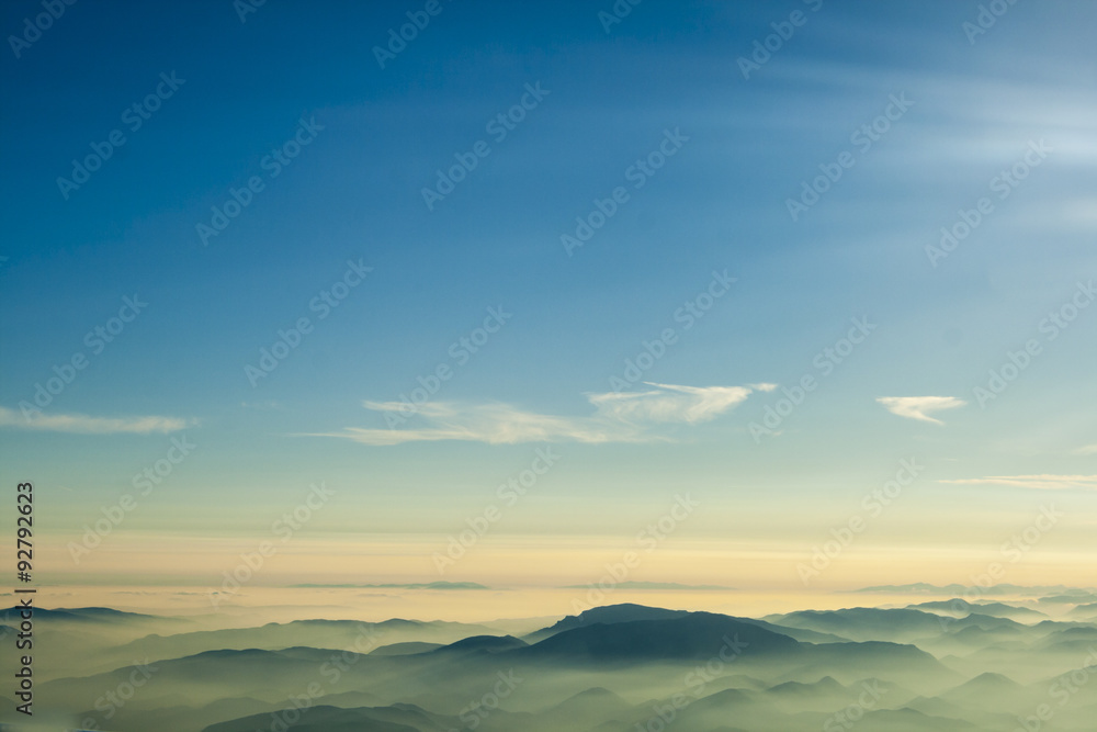 mountains clouds blue sky and fog photographed from on mountaintop