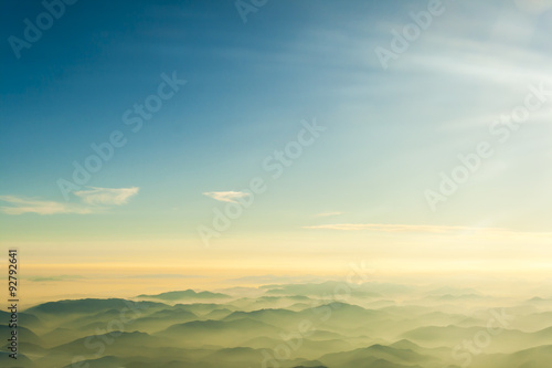 mountains clouds blue sky and fog photographed from on mountaintop