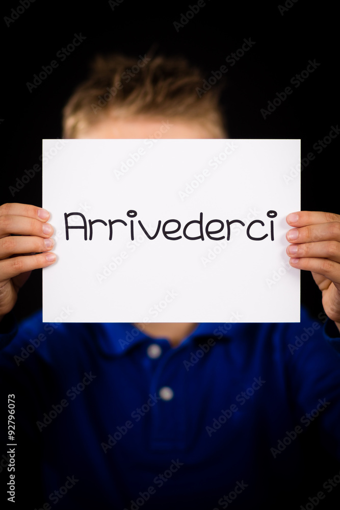 Child holding sign with Italian word Arrivederci - See you later Child holding sign with Italian word Arrivederci - See you later