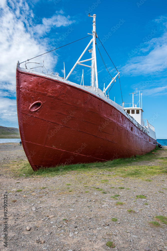 Old boat on a beach in Patreksfjordur, Westfjords, Iceland Old boat on a beach in Patreksfjordur, Westfjords, Iceland