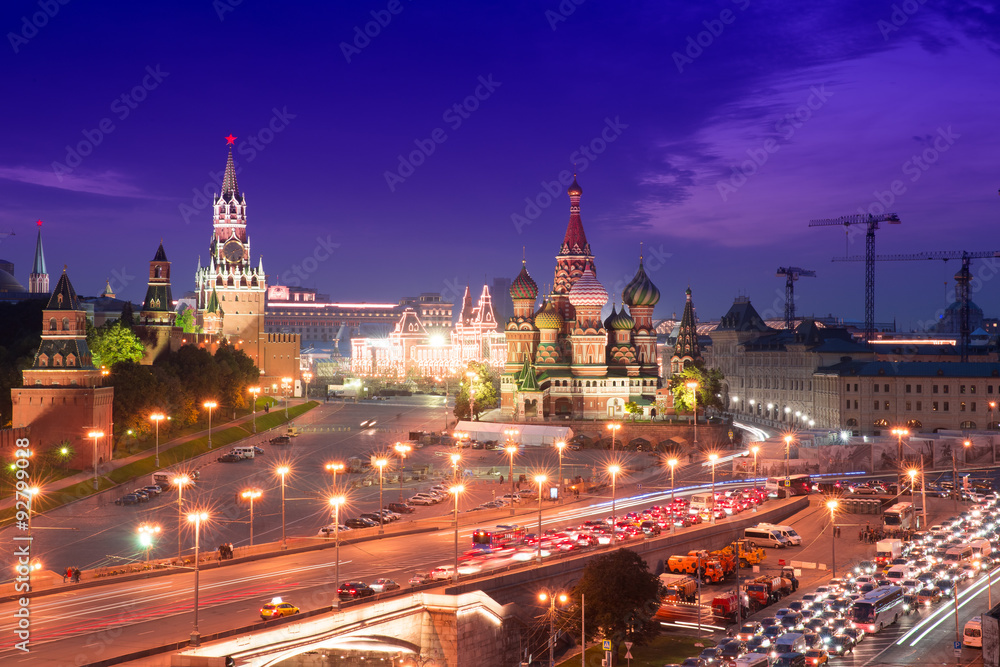 Fototapeta premium Night aerial panorama to Bolshoy Moskvoretsky Bridge, Vasilevsky Descent, towers of Moscow Kremlin, Saint Basil Cathedral, GUM and evening traffic jam