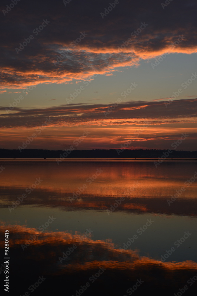 St.Aubin's Bay, Jersey, U.K. A calm still sunset reflected in a pool.