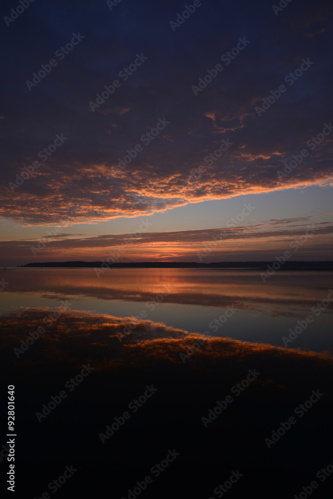 St.Aubin's Bay, Jersey, U.K.  Autumn sunset reflected in a still pool of water.