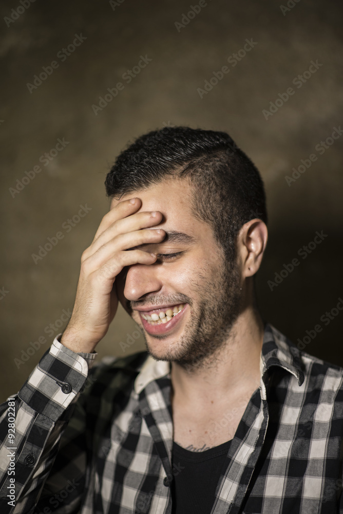 Man with cool plaid shirt posing in studio shot Man with cool plaid shirt posing in studio shot