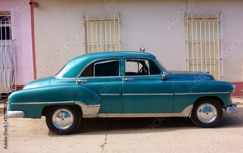 Classic American car as taxi parked in the street in front of old buildings in historic Trinidad, Cuba.  © Mikko Palonkorpi