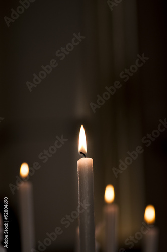 detail of some lit candles in church