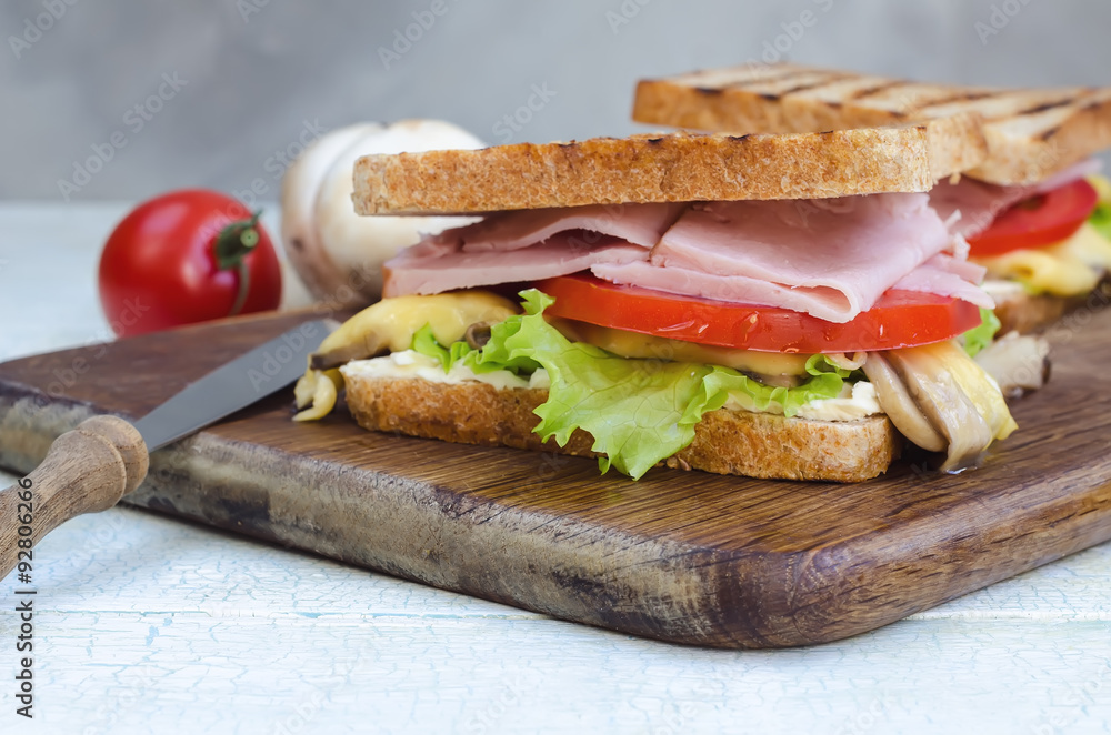 Tasty healthy sandwiches at white wooden table. Rustic style. Tasty healthy sandwiches at white wooden table. Rustic style.