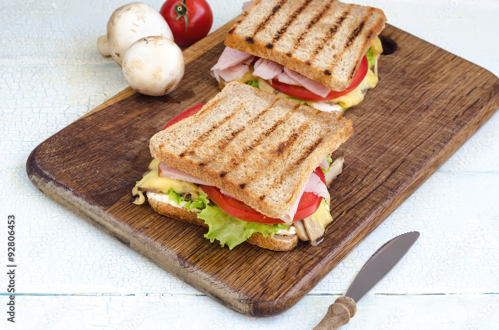 Tasty healthy sandwiches at white wooden table. Rustic style. Tasty healthy sandwiches at white wooden table. Rustic style.
