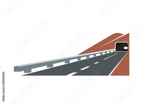 Road tunnel leading through brown hill