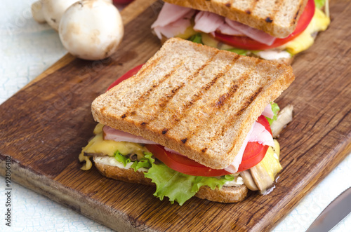 Tasty healthy sandwiches at white wooden table. Rustic style. Shallow focus