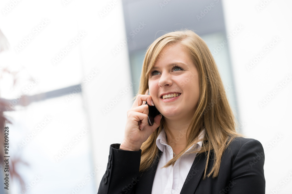businesswoman talking on a mobile phone at the office