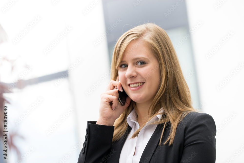 businesswoman talking on a mobile phone at the office