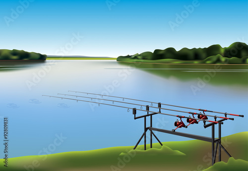 Three fishing rods beside the lake.