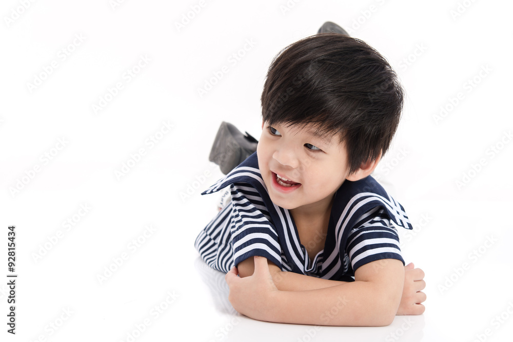 Cute asian boy lying on white background isolated Cute asian boy lying on white background isolated