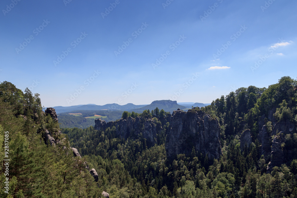 Panorama with rocks Bastei, Neurathen Castle and table mountain Lilienstein in Rathen, Saxon Switzerland