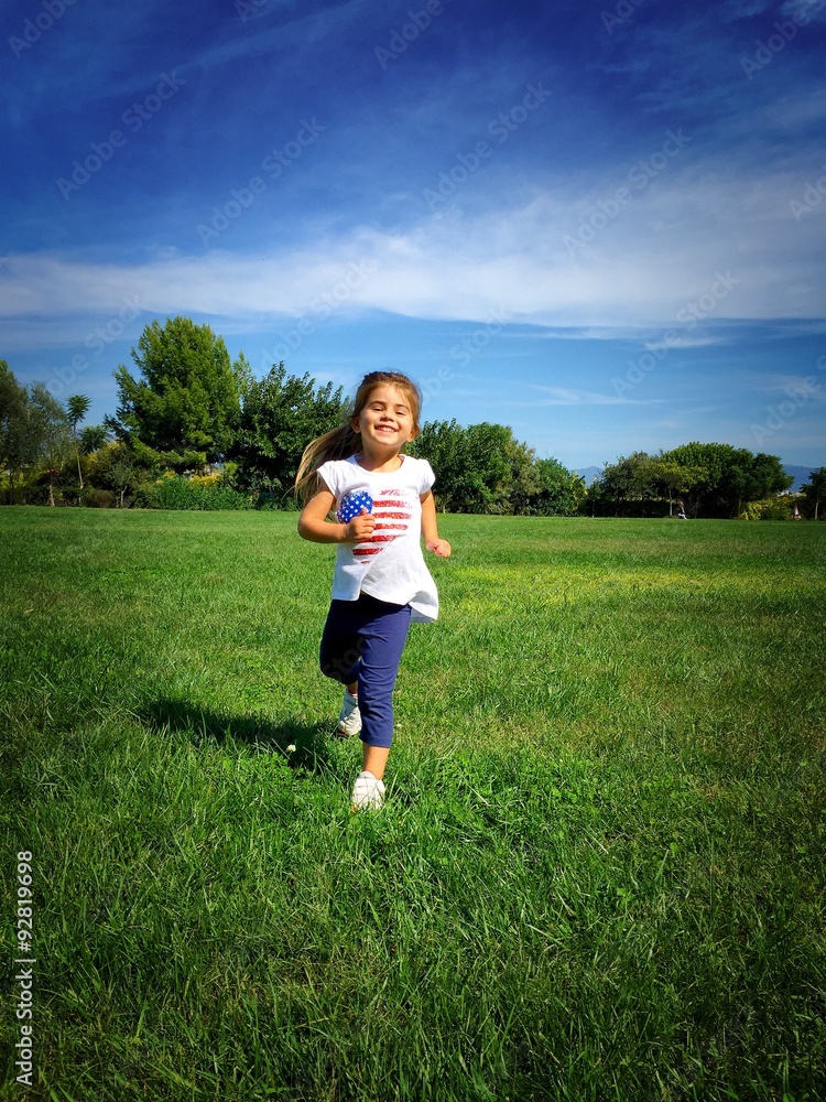 Cute little girl running at the park Cute little girl running at the park