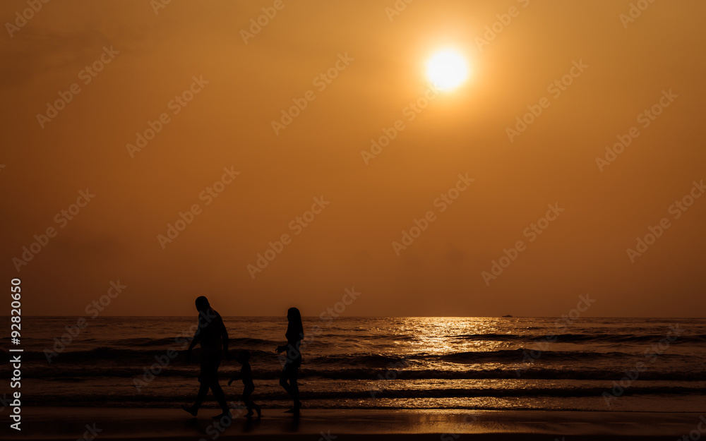 Fototapeta premium Silhouette people walking on the beach