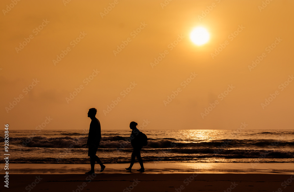 Silhouette people walking on the beach Silhouette people walking on the beach