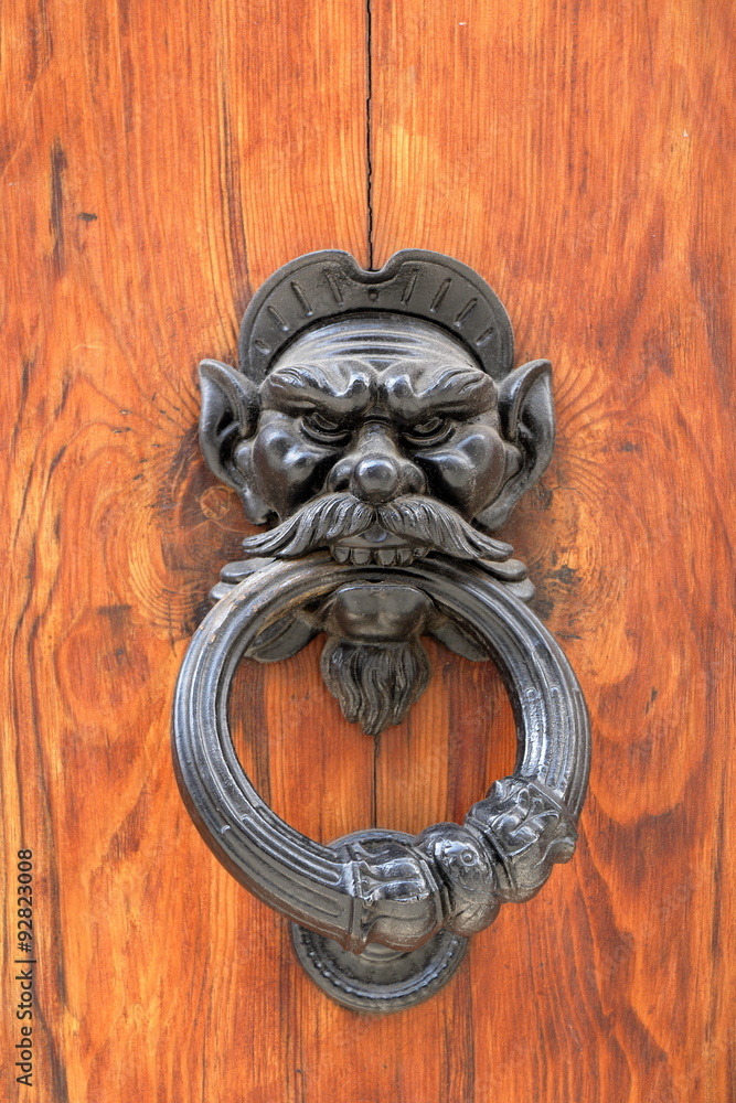 Dark wooden door with black dusty handle