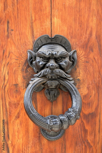 Dark wooden door with black dusty handle