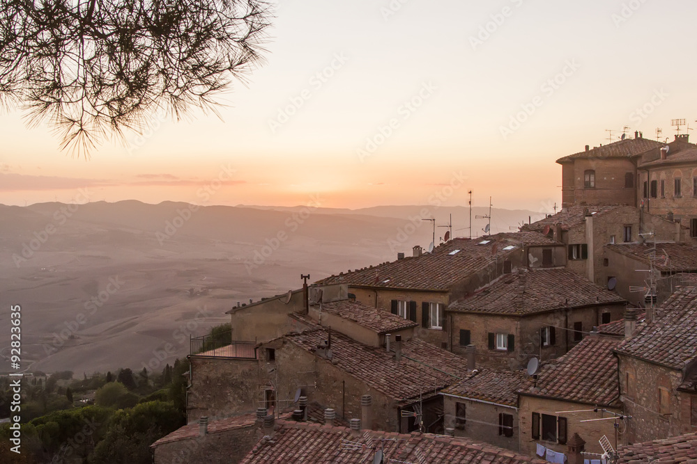 medieval Volterra, house roofs and sun, Tuscany