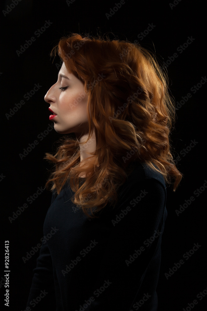 Portrait of a beautiful woman on a black background. Portrait of a beautiful woman on a black background.
