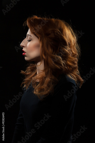 Portrait of a beautiful woman on a black background.