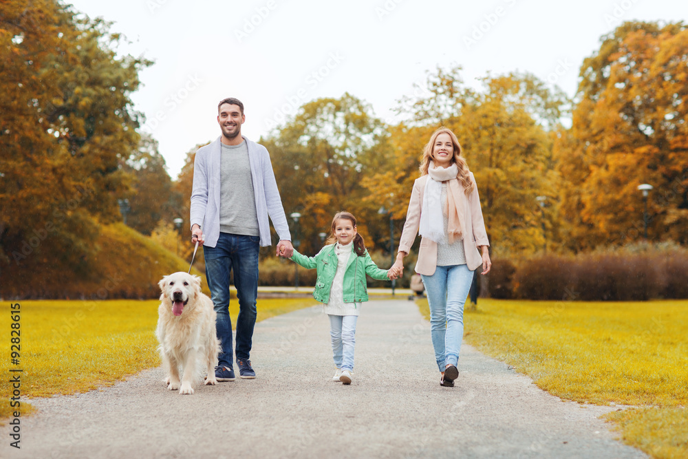 happy family with labrador retriever dog in park happy family with labrador retriever dog in park