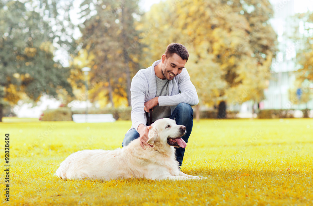 happy man with labrador dog in autumn city park happy man with labrador dog in autumn city park