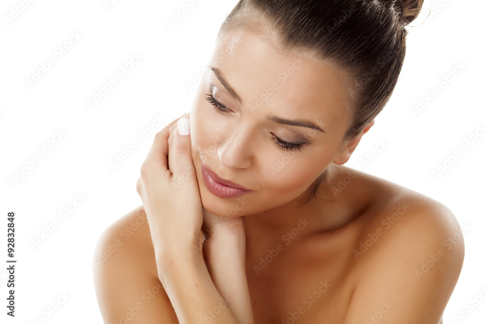 sensual young woman posing with a bun on a white background sensual young woman posing with a bun on a white background