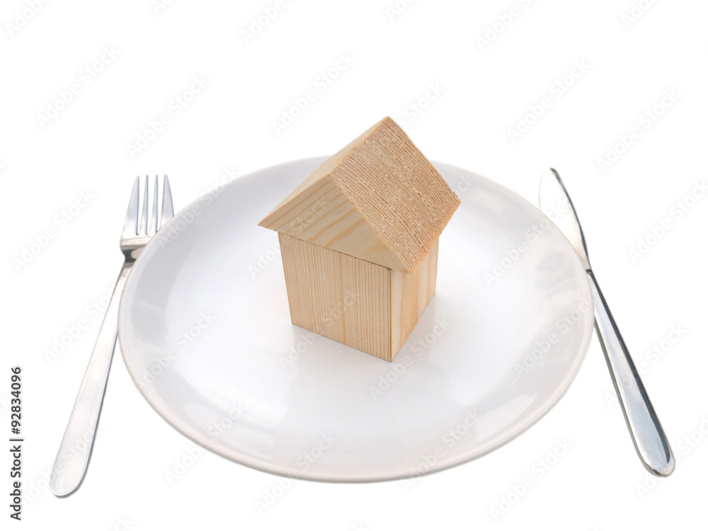 Wooden house of building blocks on the plate Wooden house of building blocks on the plate