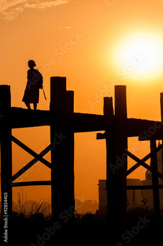 Girl on U bein bridge at sunset, Taungthaman lake, Amarapura
