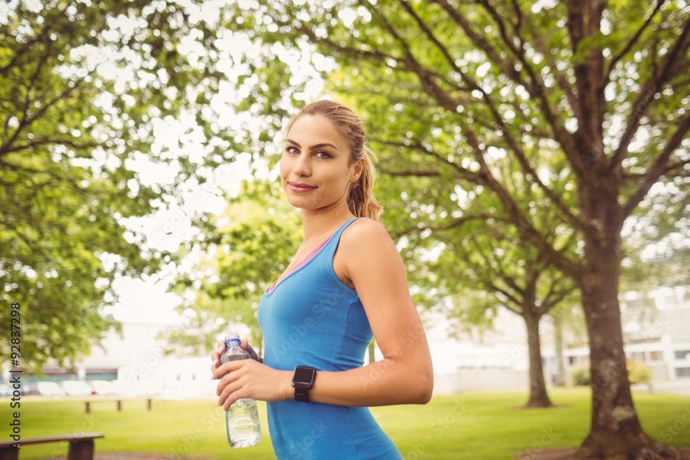 Portrait of smiling woman holding water bottle Portrait of smiling woman holding water bottle