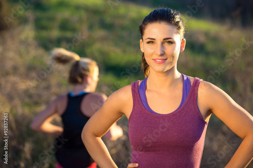 Fototapeta Naklejka Na Ścianę i Meble -  Portrait of runner jogger athlete gorgeous attractive woman outdoor exercise fit happy
