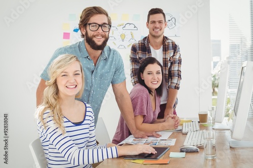 Portrait of smiling woman with coworkers 