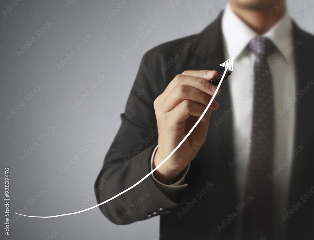 Businessman drawing graphics growing graph Businessman drawing graphics growing graph