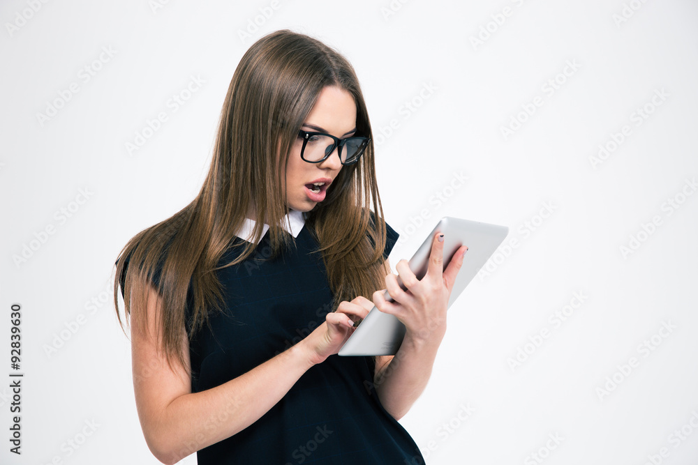 Shocked woman using tablet computer Shocked woman using tablet computer