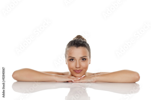 sensual young woman with a bun lying on her hands