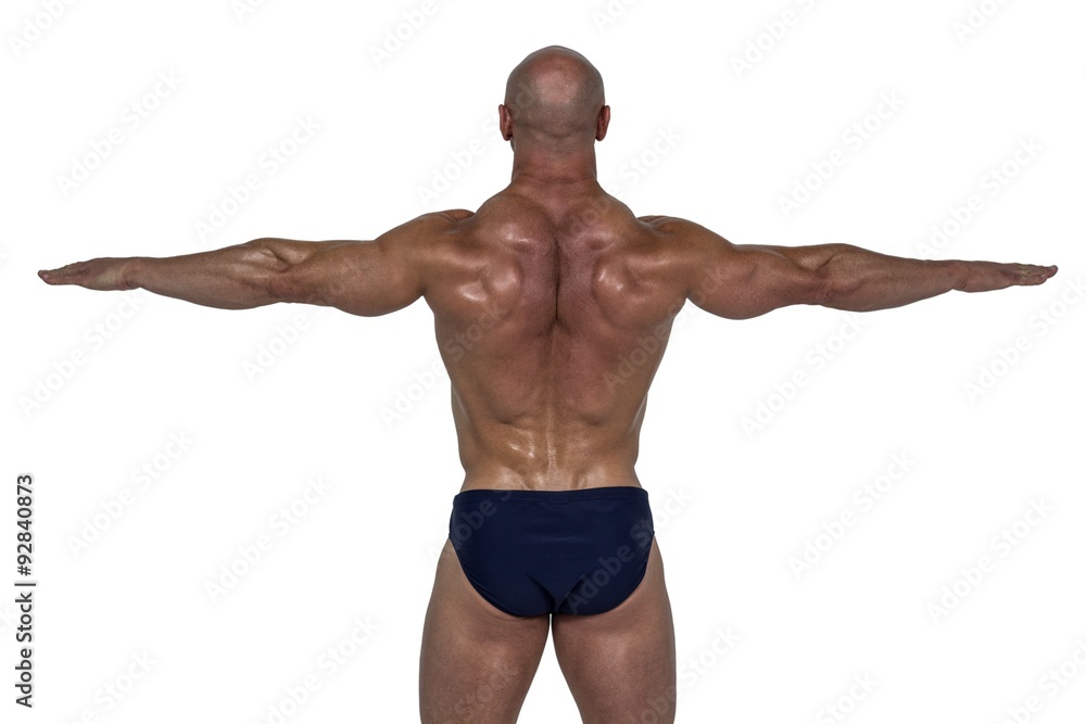 Rear view of muscular man exercising with hands Rear view of muscular man exercising with hands