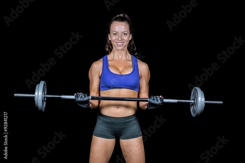Portrait of smiling woman lifting crossfit