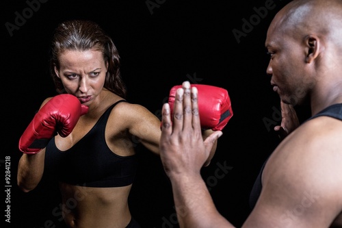 Female boxer practicing with trainer © WavebreakmediaMicro