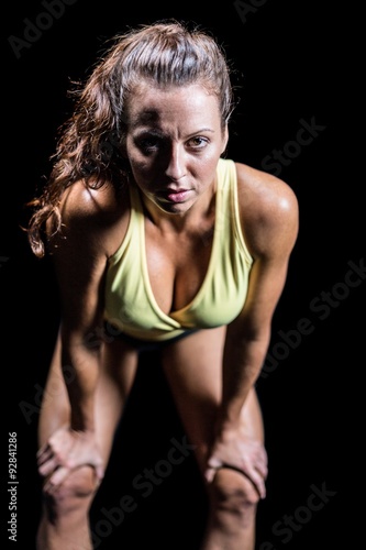 Portrait of exhausted athlete bending