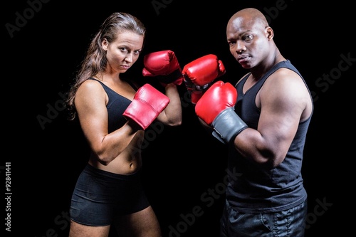 Portrait of male and female athletes with fighting stance